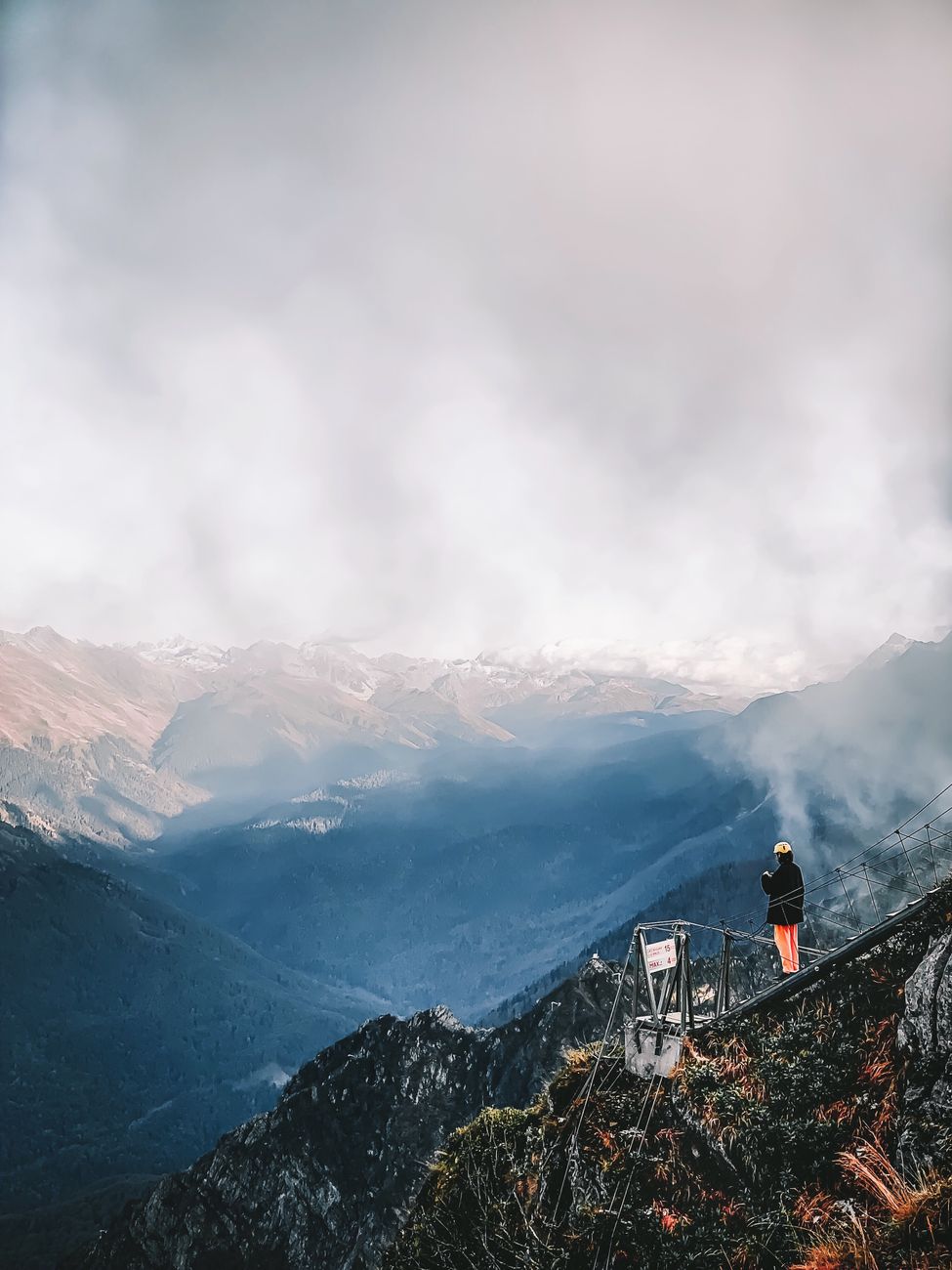 Solo traveler overlooking misty valley